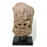 An Indian stone fragment carved with the figure of Ganesh, raised on contemporary rectangular