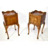 A pair of late 19th century walnut bedside cupboards, each with raised gallery tops and cut