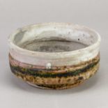 † ROBIN WELCH (1936-2019); a small stoneware bowl covered in bands of grey and mottled green glaze