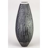 † ASHRAF HANNA (born 1967); a tall raku vessel with deeply carved surface and naked raku rim,