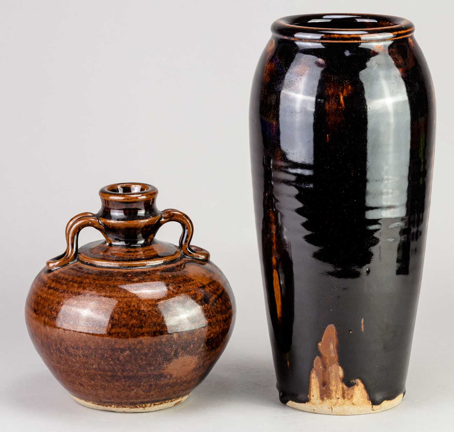 † URSULA MOMMENS (1908-2010); a tall stoneware vase covered in tenmoku breaking to kaki glaze,