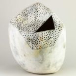 REBECCA APPLEBY (born 1979); an earthenware boulder form with a triangular aperture and perforated