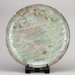 AKIKO HIRAI (born 1970); a large stoneware plate covered in celadon glaze with pink blushes and