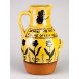 † BENNETT COOPER (1953-2002); a large slipware calligraphic jug decorated with flowers and