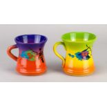 † RICHARD GODFREY (1949-2014); a near pair of earthenware mugs covered in painted and sprayed