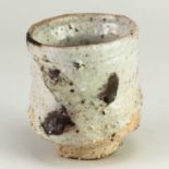 CHARLES BOUND (born 1939); a wood fired stoneware yunomi partially covered in white and pink glaze