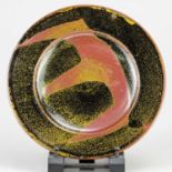 † RAY FINCH (1914-2012) for Winchcombe Pottery; a large stoneware plate covered in tenmoku and