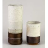† ROBIN WELCH (1936-2019); a cylindrical stoneware vessel covered in bands of grey and bronze
