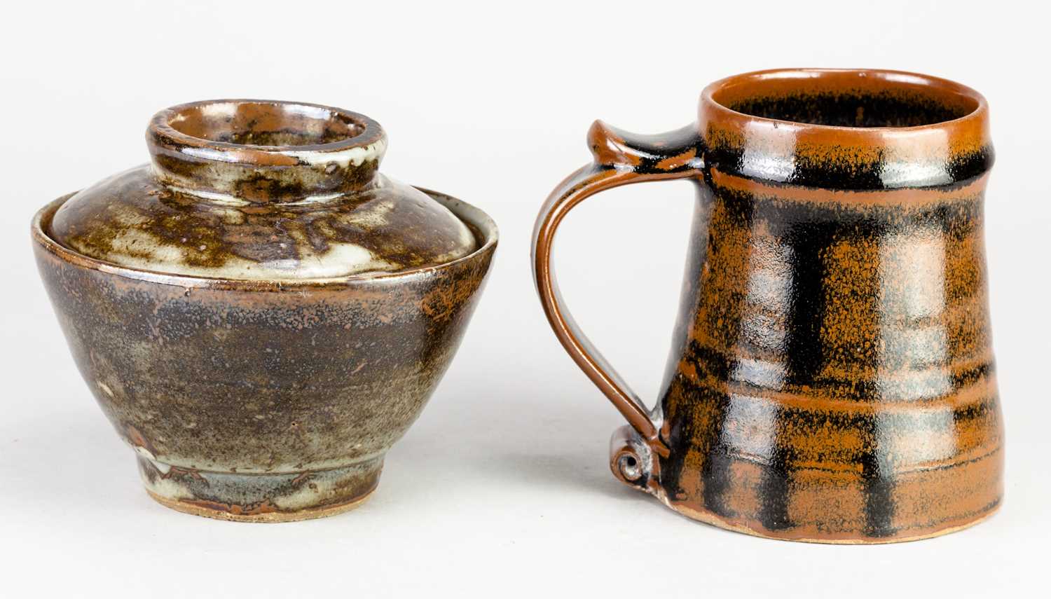 Leach Pottery; a stoneware mug covered in tenmoku breaking to kaki glaze, impressed pottery mark, - Image 2 of 6