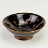 † CHARLES VYSE (1882-1971); a stoneware bowl covered in tenmoku glaze with wax resist decoration,