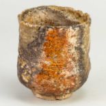 CHARLES BOUND (born 1939); a wood fired stoneware yunomi covered in shino and ash glaze, impressed