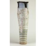† ROBIN WELCH (1936-2019); a tall stoneware vessel with pierced pale blue top and bronze rim and