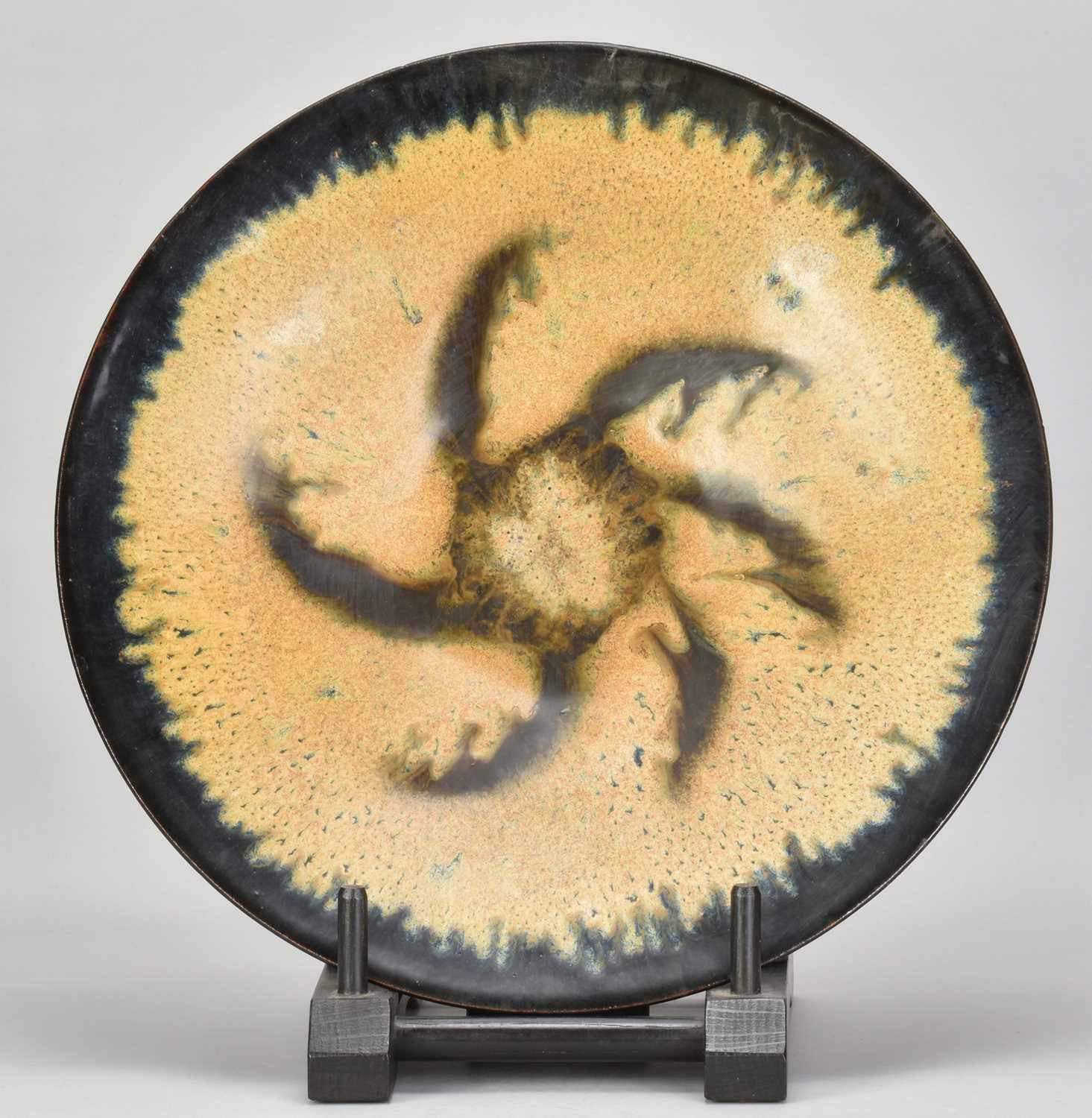 † ABDO NAGI (1941-2001); a stoneware charger/wall hanging covered in mottled yellow and blue glaze