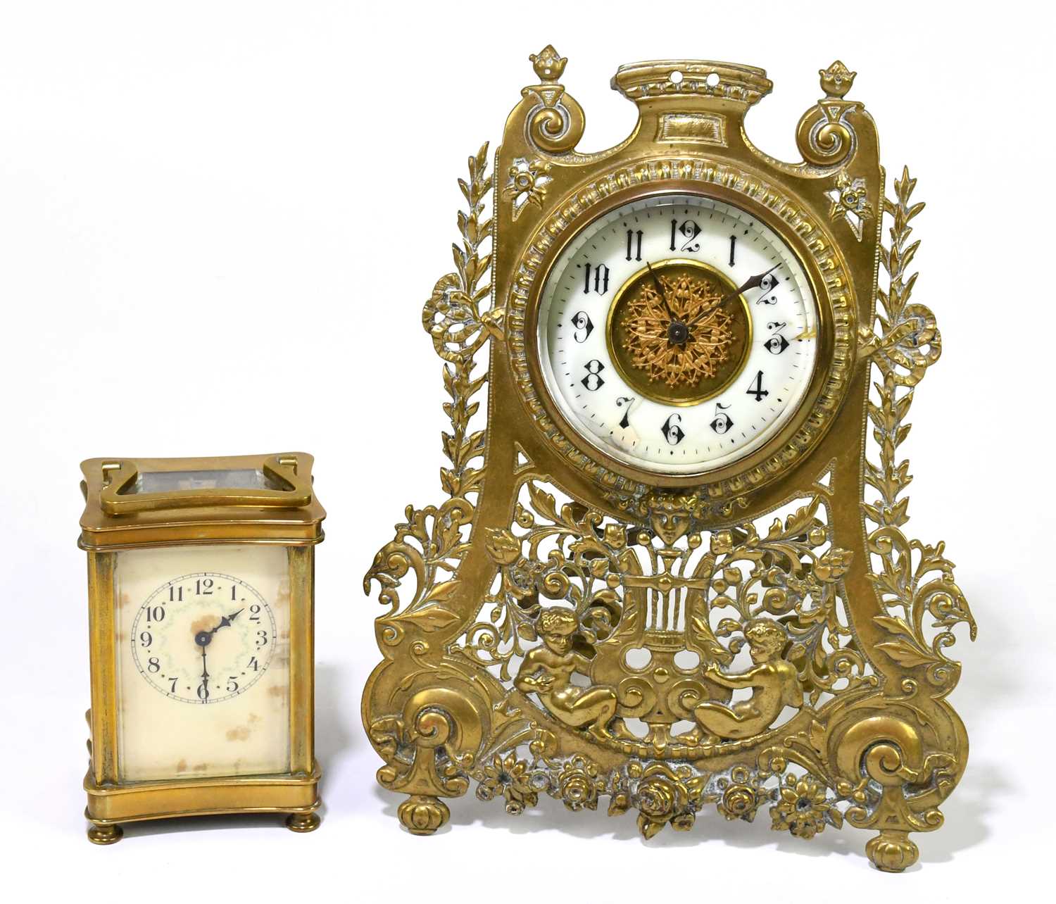 A late 19th /early 20th century brass easel back mantel clock with carved and pierced decoration