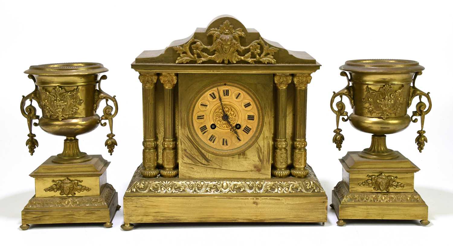A late 19th century French gilt brass eight day clock garniture, with Roman numeral dial and