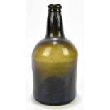 An 18th century black glass wine bottle with kick-up pontil, height 21.5cm.Condition Report: There