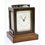 A late 19th century French rosewood cased carriage clock with Roman numerals to the white enamel