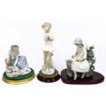 NAO; three figure groups comprising ballerina, height 29cm, maiden with cat and girl with doves,