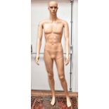 A modern sectional male shop mannequin, on a glass base, life size.