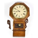 An American carved walnut drop dial wall clock, the painted dial set with Roman numerals above