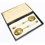 A pair of late Victorian gilt plated serving spoons, with mother of pearl handles, length 23.5cm,