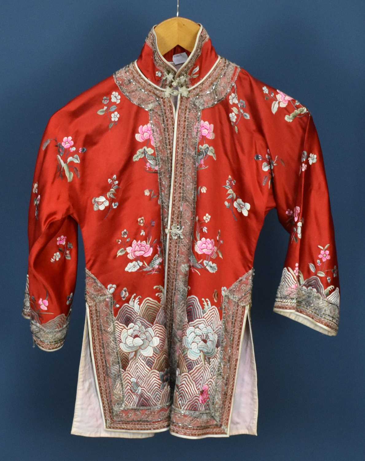 A red 1960s silk satin lined Chinese jacket with a floral embroidered pattern to front and back with