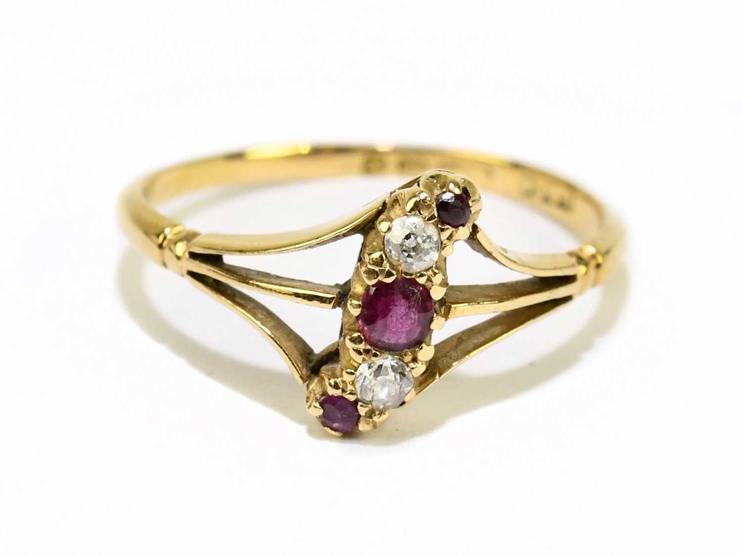 An 18ct yellow gold ruby and diamond five stone ring of pierced swept design, size Q, approx, 2.5g.