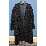 A vintage black Persian lamb full length lined coat with long sleeves and unusual black beaded front