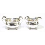 ALEXANDER CLARK & CO; a George V hallmarked silver twin handled sugar bowl with matching cream