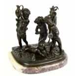 A late 19th century bronze figure group modelled as four putti beside a rearing goat, on marble