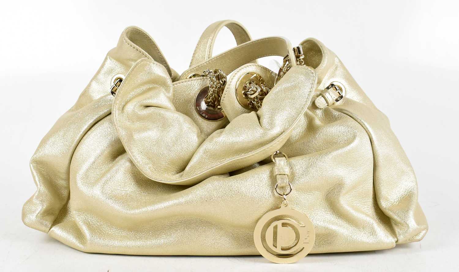 CHRISTIAN DIOR; a metallic gold leather 'Le Trente Hobo' handbag, hand stitched with heavy gold tone