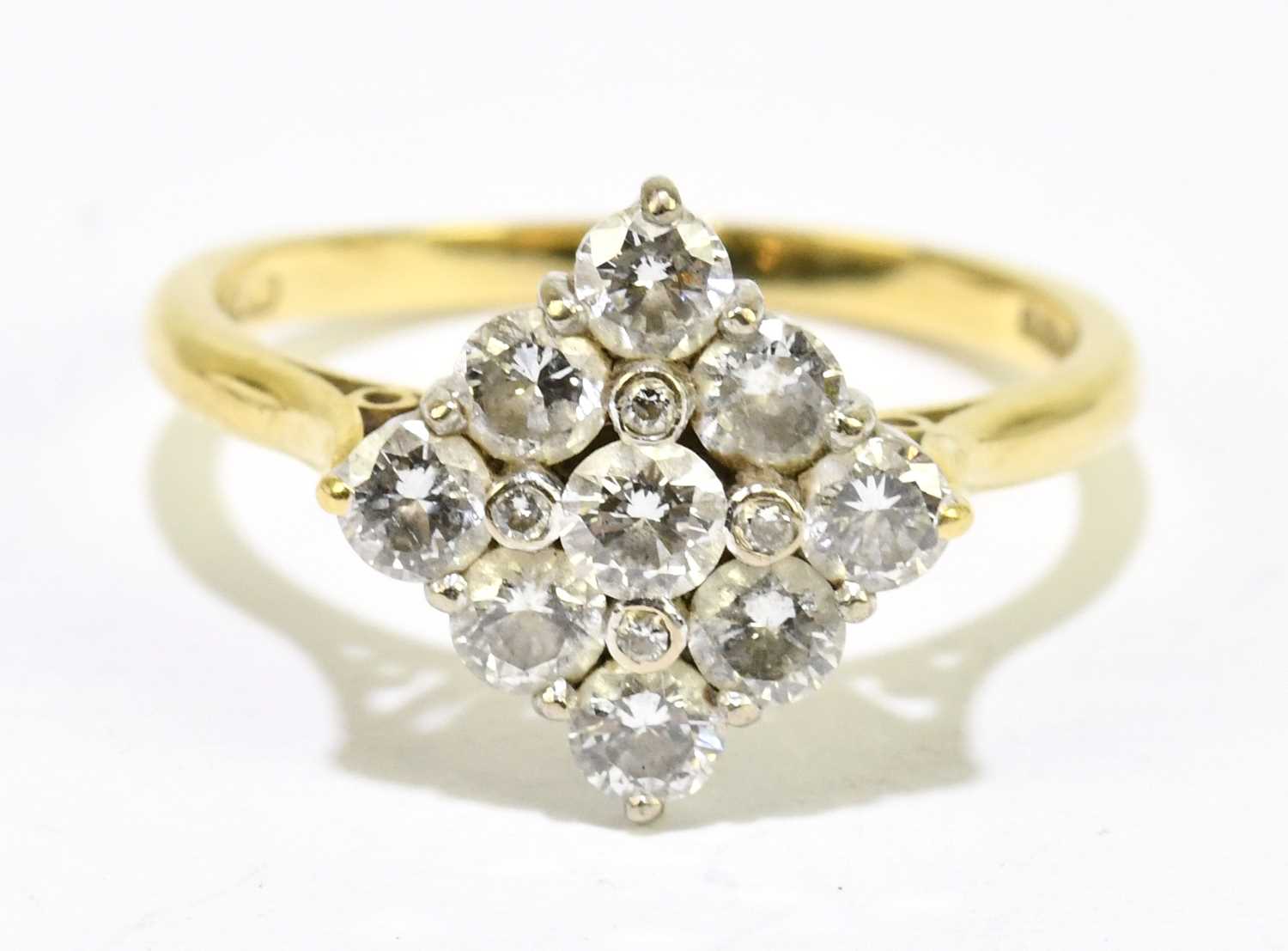 An 18ct yellow gold and diamond lozenge shaped cluster ring, the largest round brilliant cut stone