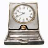GOLDSMITHS & SILVERSMITH CO; a George V hallmarked silver travelling clock, with engine turned