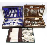 Two oak cased canteens of cutlery and flatware and a further cased canteen of silver plated