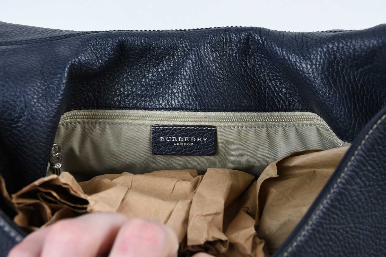 BURBERRY; a navy blue pebbled leather shoulder bag with thick top handle, white stitching detail, - Image 5 of 5