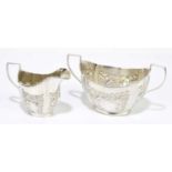 JONES & COMPTON; an Edward VII hallmarked silver twin handled sugar bowl and matching cream jug,