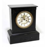 A Victorian slate mantel clock of rectangular form, the circular enamel dial set with Roman