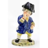 A Staffordshire type figure of a portly gentleman taking snuff, on a sponged type base, with