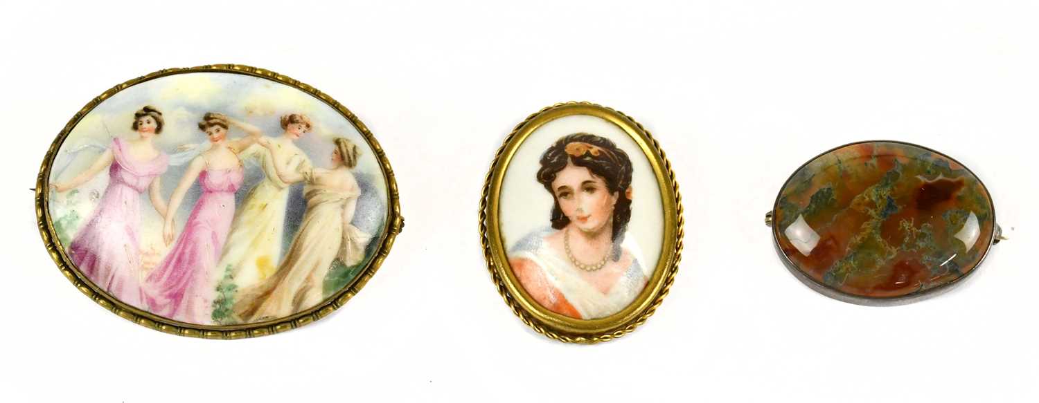 A Continental gilt metal mounted porcelain brooch decorated with four muses, length 6.5cm, with a