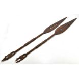 Two 20th century African ceremonial carved wood spears/paddles, height 124cm (2)