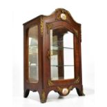 A reproduction French gilt metal mounted walnut cabinet, with bevelled glazed door enclosing two