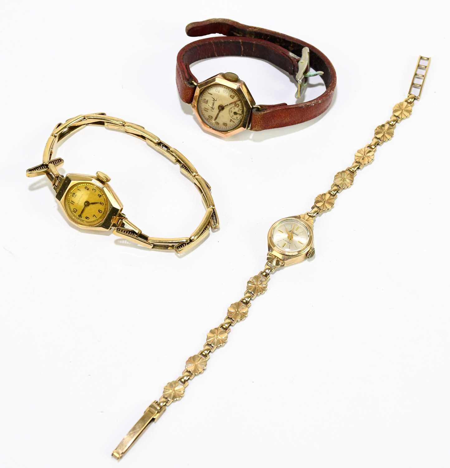 ACCURIST; a lady's 9ct gold cased wristwatch with 9ct gold floral bracelet, the silvered dial set