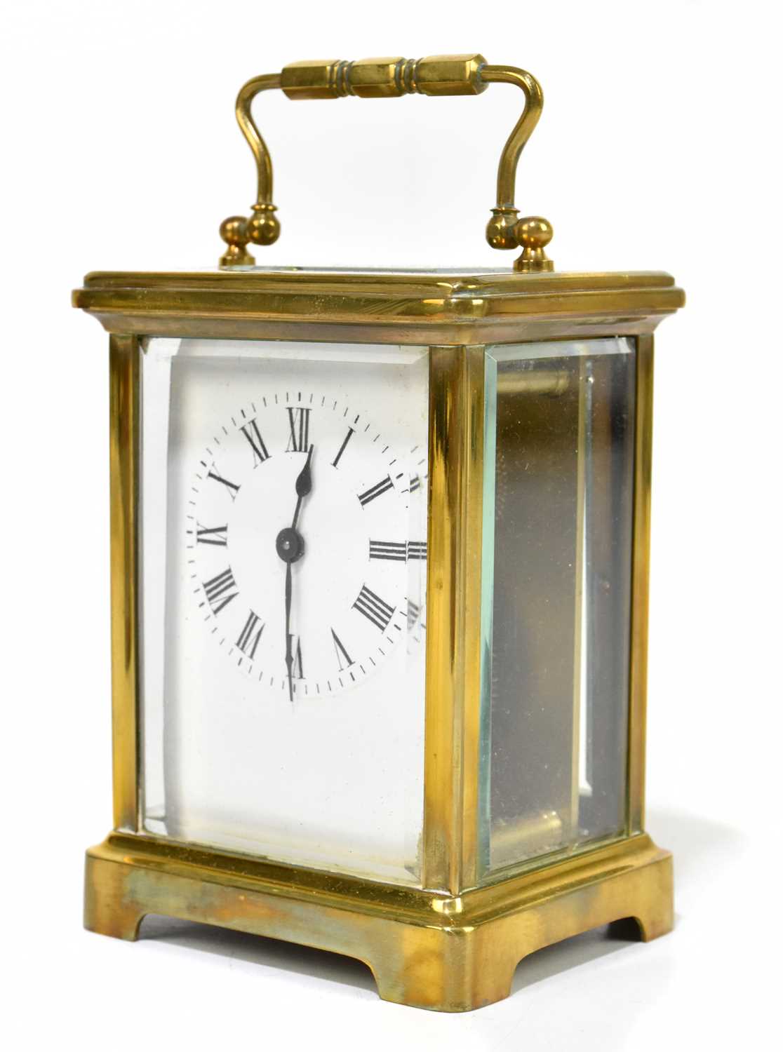 A late 19th century French lacquered brass carriage time piece, with enamelled Roman numeral dial