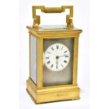 A late 19th century French brass cased carriage clock with swing loop handle above silvered dial set
