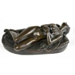 AFTER JEAN JACQUES PRADIER; a cast bronze sculpture of a nude maiden lying on a bed, length 20cm.