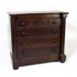 A 19th century mahogany apprentice chest of three short over three long drawers, flanked by turned