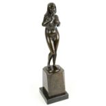 H. S. MCHEN; an Art Deco bronze figure of a nude figure raised on a polished stepped base, signed to