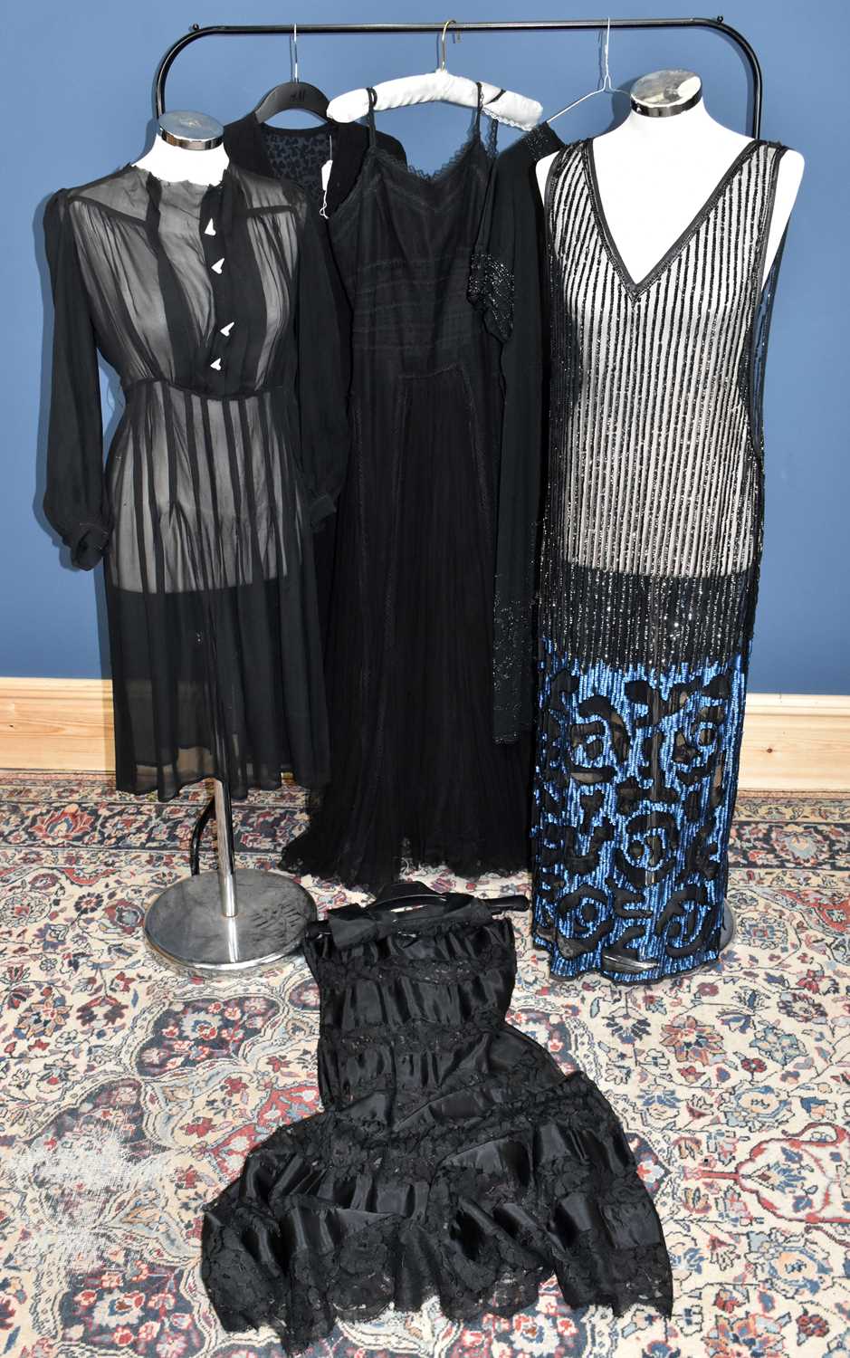 A black sequinned full length 1920s flapper dress style tunic with an electric blue sequin design,