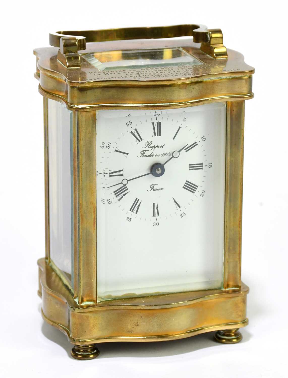 RAPPORT; a French brass cased carriage clock, the enamelled dial set with Arabic and Roman numerals,