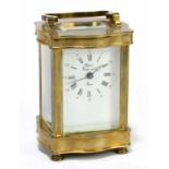 RAPPORT; a French brass cased carriage clock, the enamelled dial set with Arabic and Roman numerals,